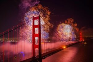 red, orange and purple fireworks over the golden gate bridge in san francisco